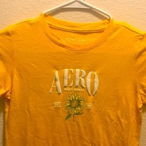 Bright yellow Aeropostale shirt with cute design size women’s XS.